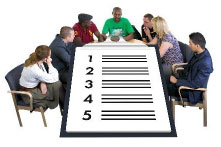People sitting round a table with a checklist