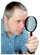 person looking through magnifying glass